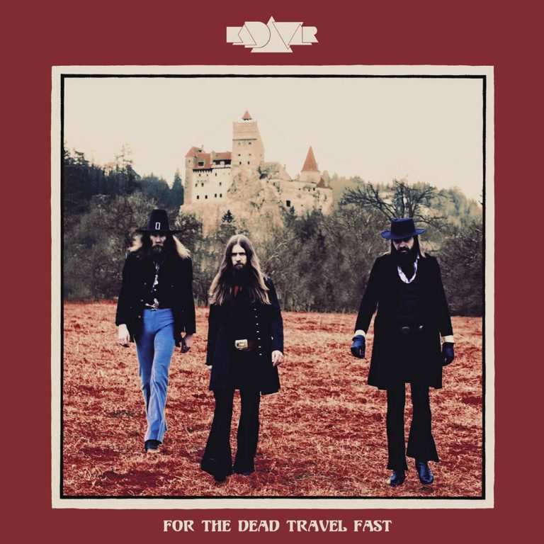 Drei Männer in Vintage-Kleidung vor einer Burg auf einem roten Feld.
