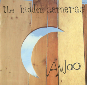 Coverbild des Albums Awoo von The Hidden Cameras mit einem Holzdesign und einem Mondsymbol.