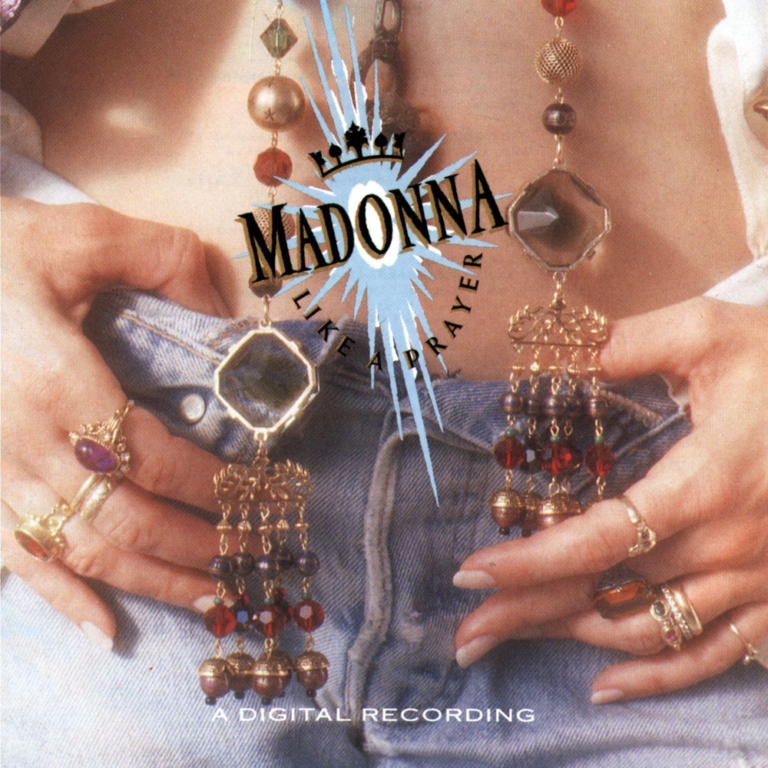Albumcover von Like A Prayer mit Schmuck und einer Jeanshose im Hintergrund.