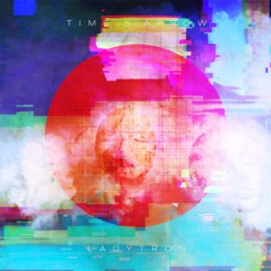 Cover von „Time’s Arrow“ von Ladytron: grell-bunte, glitch-artige Grafik mit zentralem roten Kreis, digital verzerrt und futuristisch inszeniert.