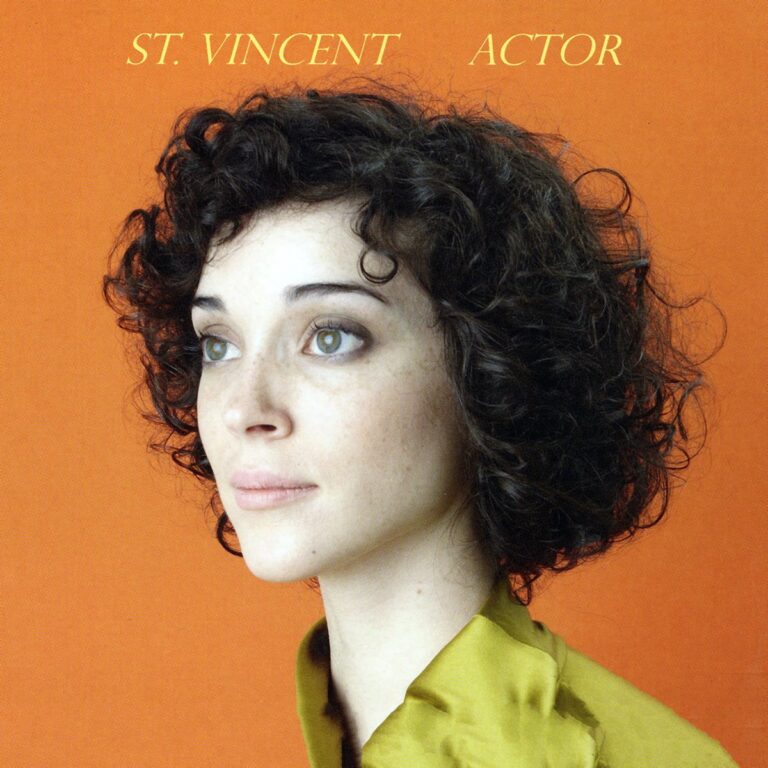 Porträt von St. Vincent vor orangefarbenem Hintergrund.