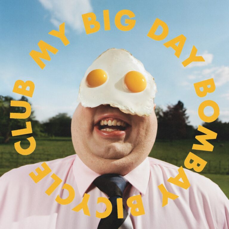 Cover von My Big Day: Ein lachender Mann im Anzug trägt zwei Spiegeleier auf den Augen, umgeben vom kreisförmigen Schriftzug „Bombay Bicycle Club“.