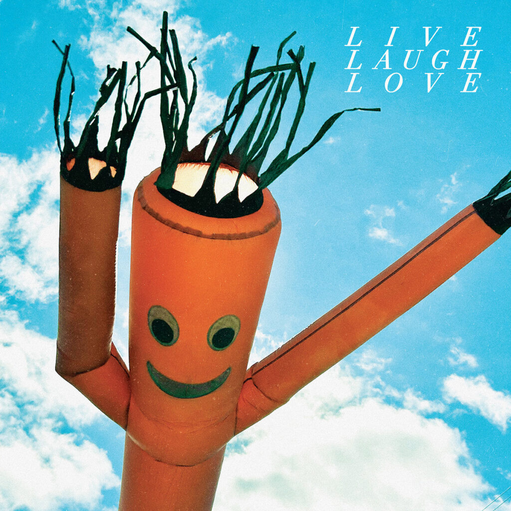 Albumcover von Chastity Belt – Live Laugh Love mit aufblasbarer Werbefigur vor blauem Himmel und ironisch anmutendem Schriftzug.
