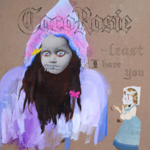 Cover der Single „Least I Have You“ von CocoRosie: Eine kindlich gemalte Figur mit dunklem Haar und Kapuze blickt ernst, daneben eine gezeichnete Puppe – surreal und traumartig.