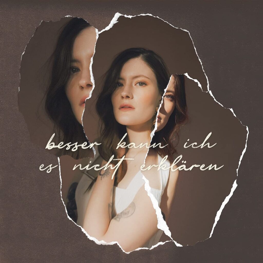 Zerrissenes Albumcover von Madeline Junos Besser kann ich es nicht erklären, zeigt die Sängerin in mehreren fragmentierten Perspektiven vor dunklem Hintergrund.