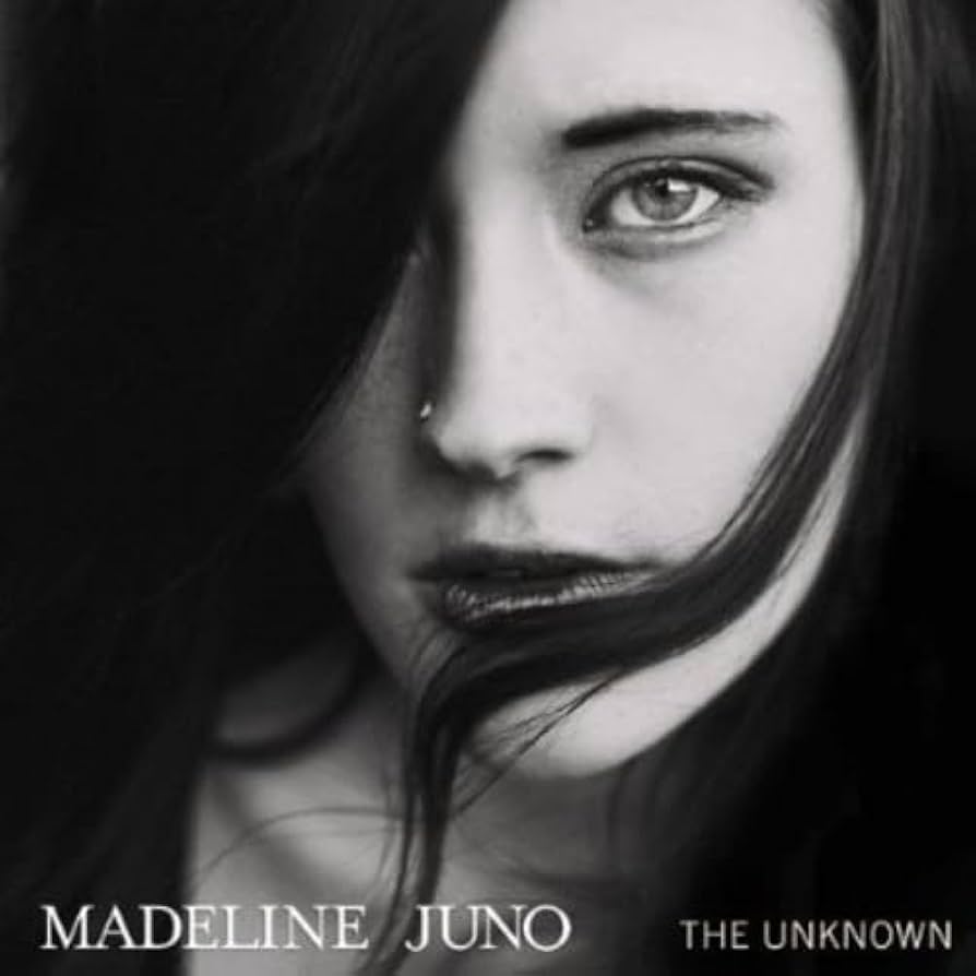 Cover des Albums „The Unknown“ von Madeline Juno – Schwarz-Weiß-Porträt der Künstlerin mit ernstem Blick und dunklem Haar, 2014 erschienen.