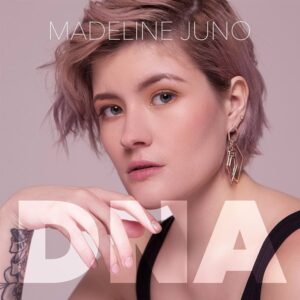 Madeline Juno mit kurzem Haar und ernstem Blick, minimalistisches rosa Albumcover von DNA.