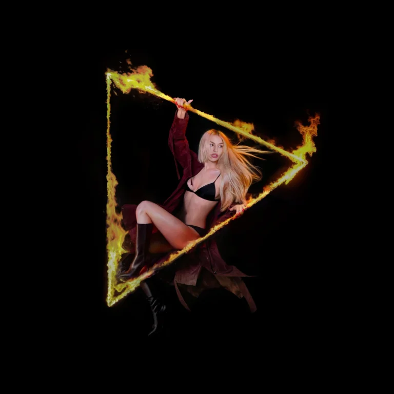 Ava Max sitzt im schwarzen Raum in einem brennenden Dreieck, mit wehenden Haaren und entschlossener Pose – Sinnbild für ihr neues Album.