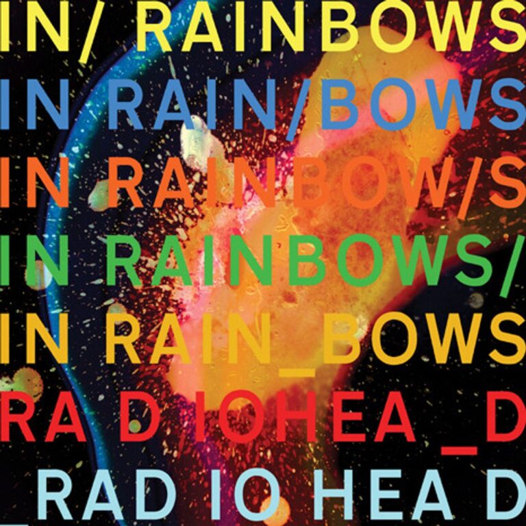 Buntes Albumcover von Radiohead – In Rainbows, mit leuchtenden Farbexplosionen und typografischen Schriftzügen vor dunklem Hintergrund.