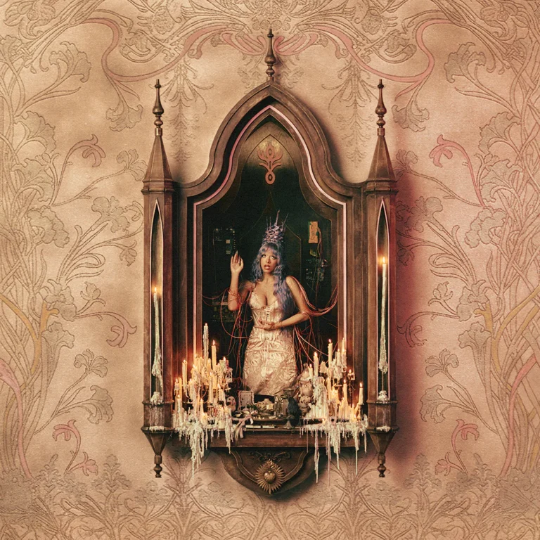 Das quadratische Albumcover zeigt Melanie Martinez mit langen, blaulila Haaren und einer dornenartigen Krone in einer nischenartigen, hölzernen Schrein-Architektur. Sie trägt ein helles, korsettartiges Kleid und ist von zahlreichen brennenden, heruntergebrannten Kerzen sowie roten Kabeln umgeben. Der Hintergrund besteht aus einer hellbeigen Tapete mit filigranen, floralen Ornamenten im Jugendstil.