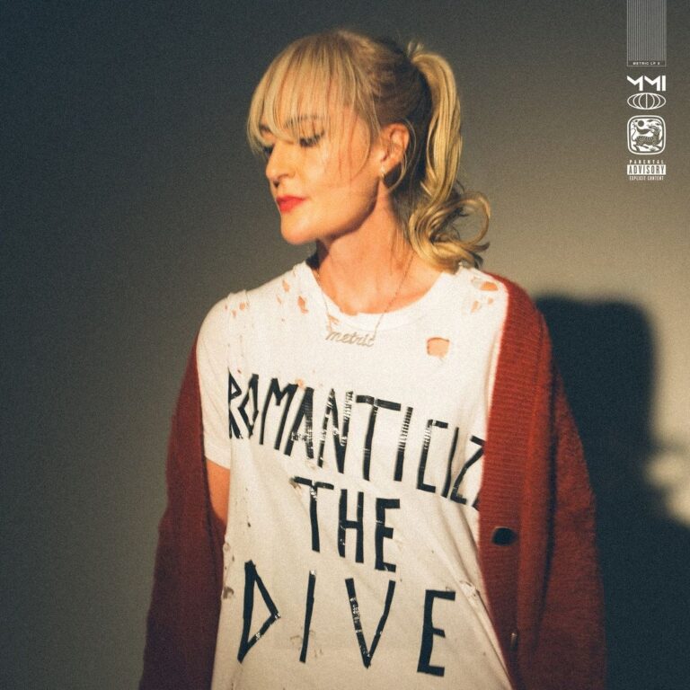 Das quadratische Albumcover zeigt die Sängerin Emily Haines in einer Halbkörperaufnahme vor einem neutralen, grauen Hintergrund. Sie trägt ein weißes, zerrissenes T-Shirt mit der schwarzen Aufschrift „ROMANTICIZE THE DIVE“ und einen dunkelroten Cardigan, der locker über ihren Schultern hängt. Ihr blondes Haar ist zu einem Pferdeschwanz gebunden, sie blickt mit geschlossenen Augen und rotem Lippenstift nach unten links. Oben rechts befinden sich mehrere minimalistische Logos und ein Warnhinweis für explizite Inhalte.